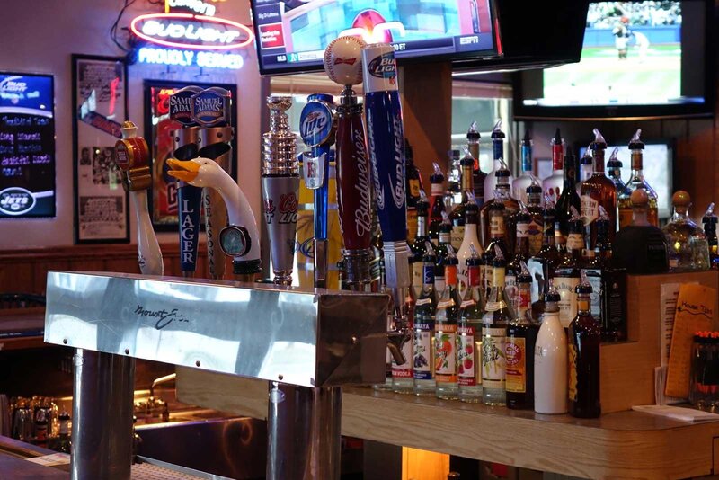 Bar beer taps with liquor bottles